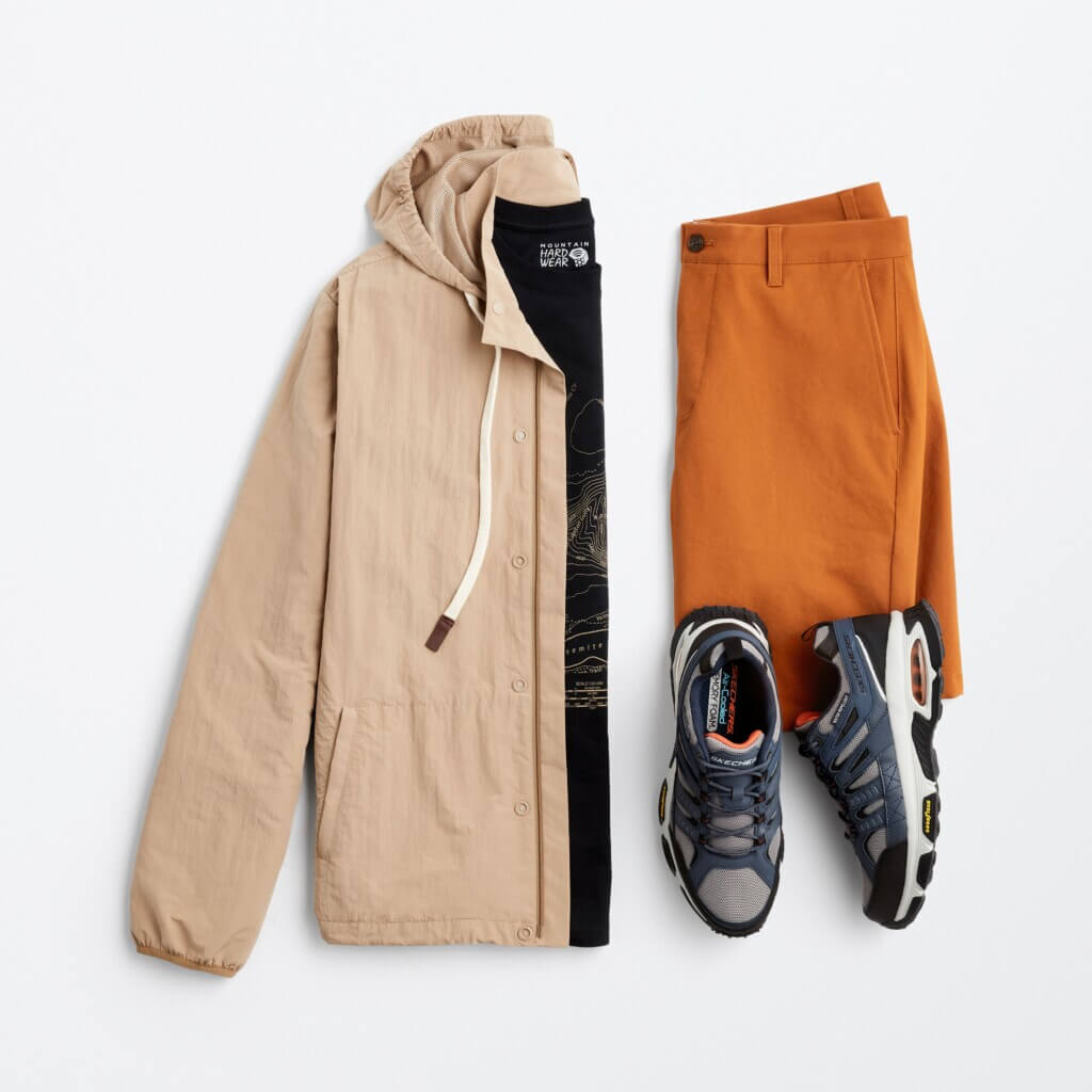 A lightweight tan jacket, orange shorts and sneakers.