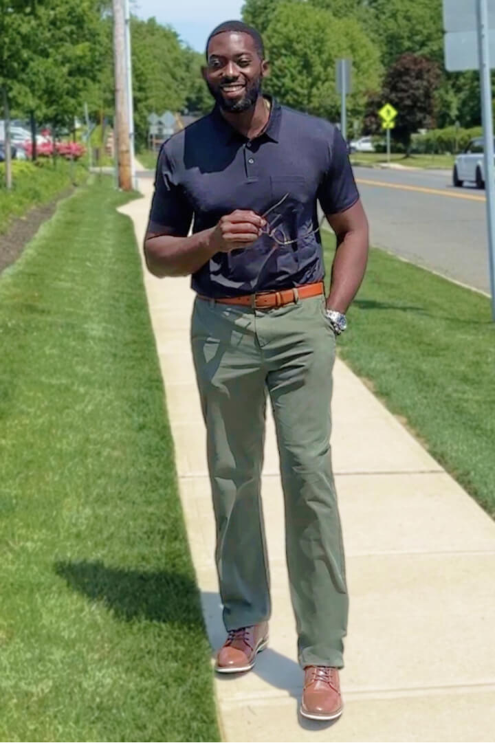Man in big and tall outfit with khakis and polo shirt