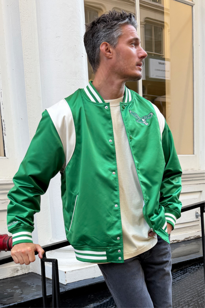 man in philadelphia eagles mitchell & ness jacket