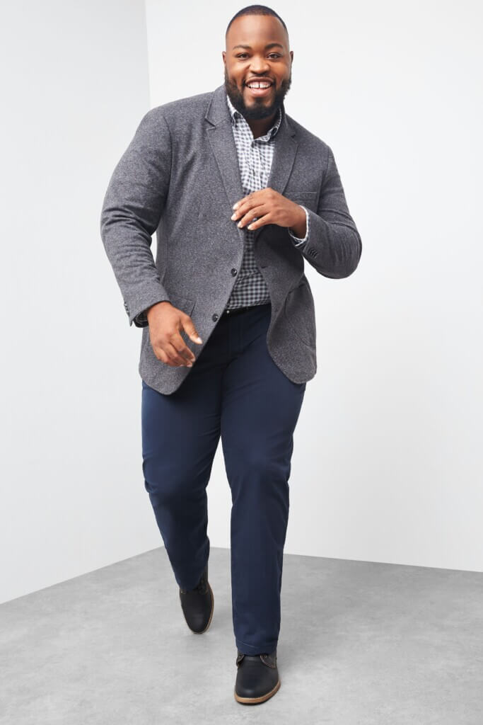 Stitch Fix model wearing men’s fall wedding attire with navy pants, blue plaid shirt, grey blazer, black shoes.