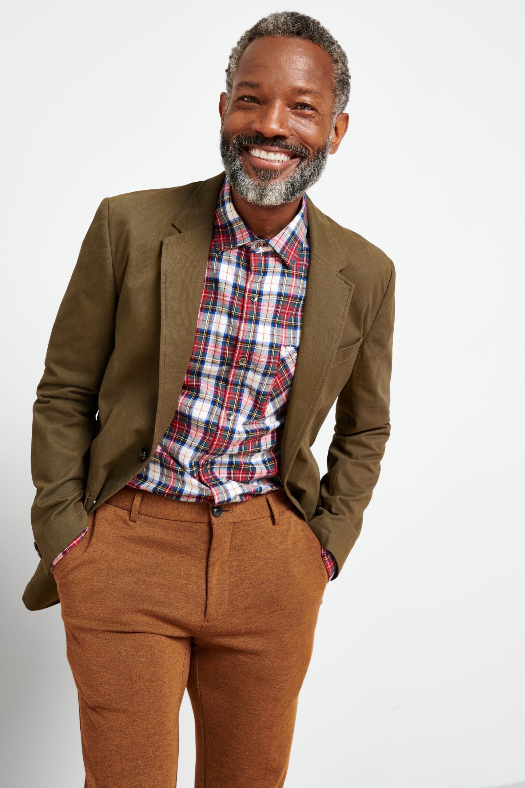 Stitch Fix model wearing men’s fall wedding attire outfit featuring red and white button-down, brown chinos, brown blazer.