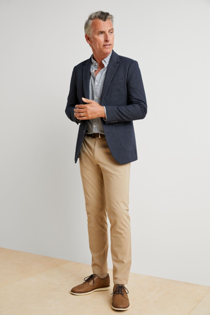 Stitch Fix men’s fall wedding attire outfit featuring khaki pants, blue plaid shirt, navy blazer, brown belt, brown shoes.
