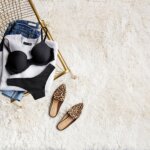 Stitch Fix women’s petite large bust outfit including bra and panties set, jeans, sweater and flats on gold chair and rug.