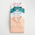 Stitch Fix Men’s laydown featuring peach, white, teal and pink stacked polo shirts.