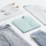Stitch Fix Men’s laydown featuring a mint T-shirt, striped crewneck, navy hoodie, blue shorts and white sneakers.