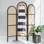 Stitch Fix women’s luxury fabric black and white striped knit maxi dress hanging on dressing screen with purple sneakers next to potted plant.