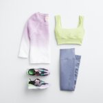 Stitch Fix women's yoga outfit featuring purple and white ombre shirt, green sports bra, purple leggings and black sneakers.