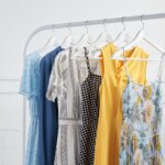 Stitch Fix maternity clothing collection featuring solid dresses in a variety of colors and prints hanging on rack.