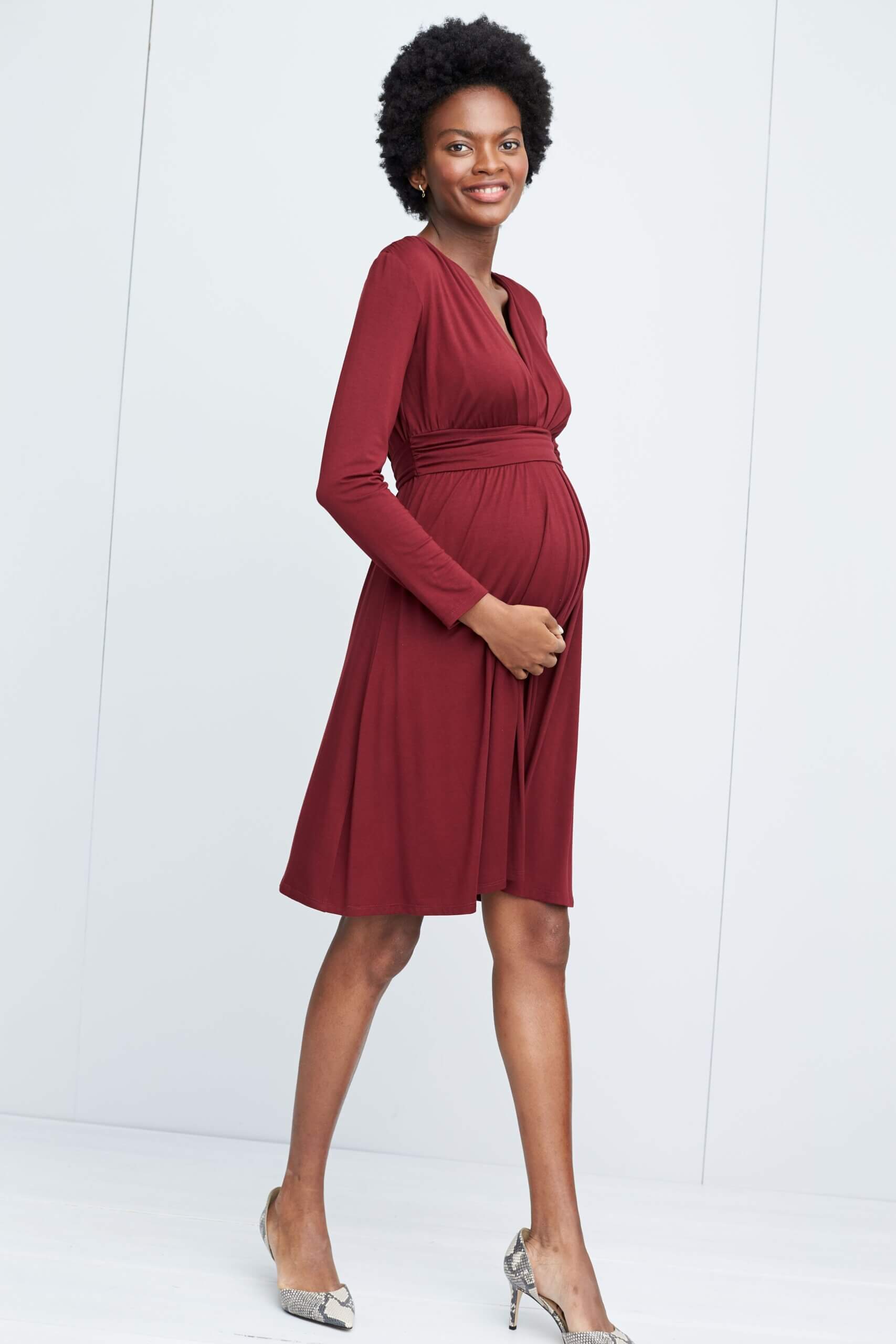 Stitch Fix women's model wearing burgundy dress and heels. 