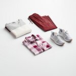 Stitch Fix Women’s outfit featuring burgundy joggers, plaid button-down shirt, colorblock pullover and grey sneakers.