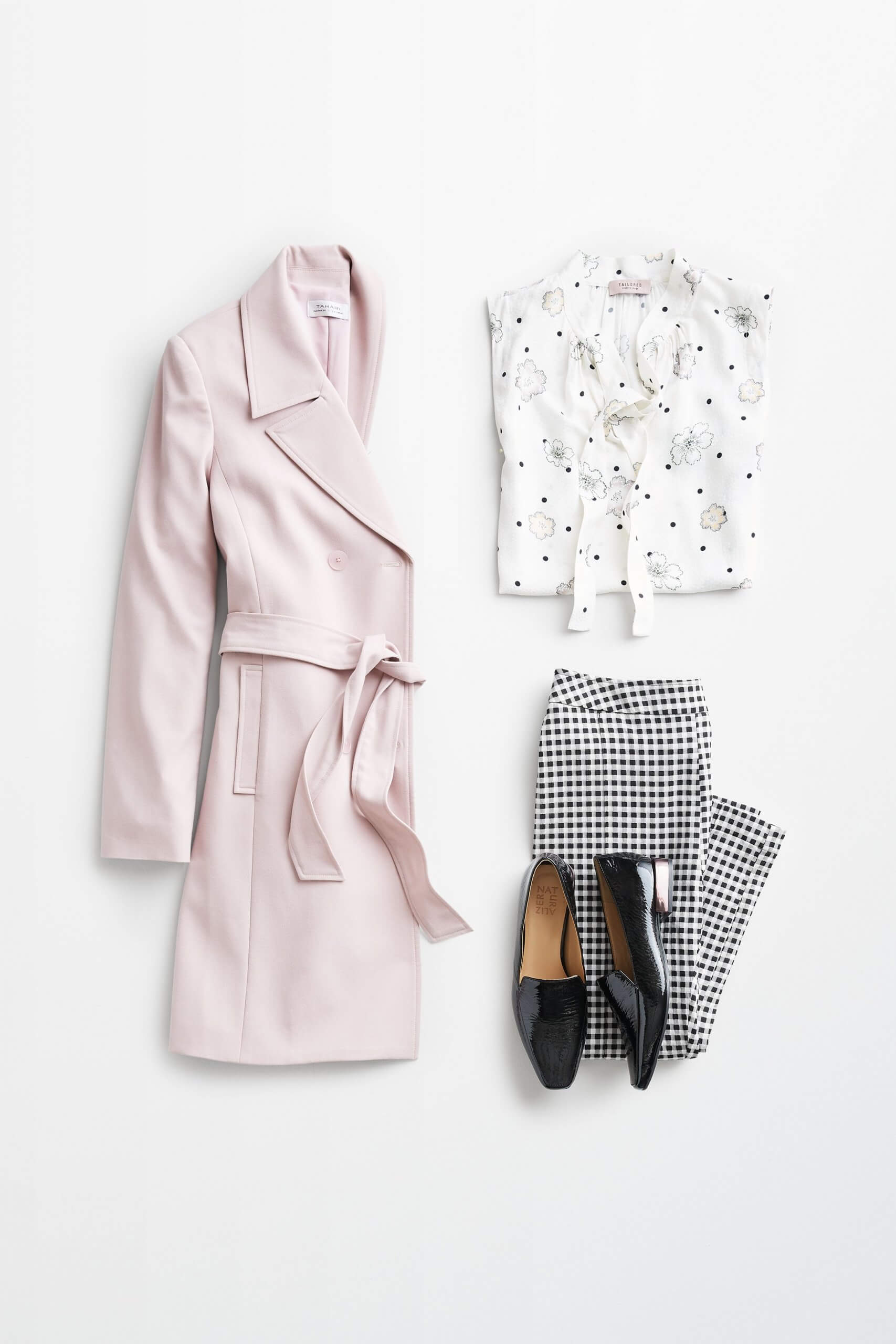 Stitch Fix women’s outfit laydown showing how to mix prints and patterns featuring light pink trench coat, floral tie-neck blouse, plaid pants and black loafers.