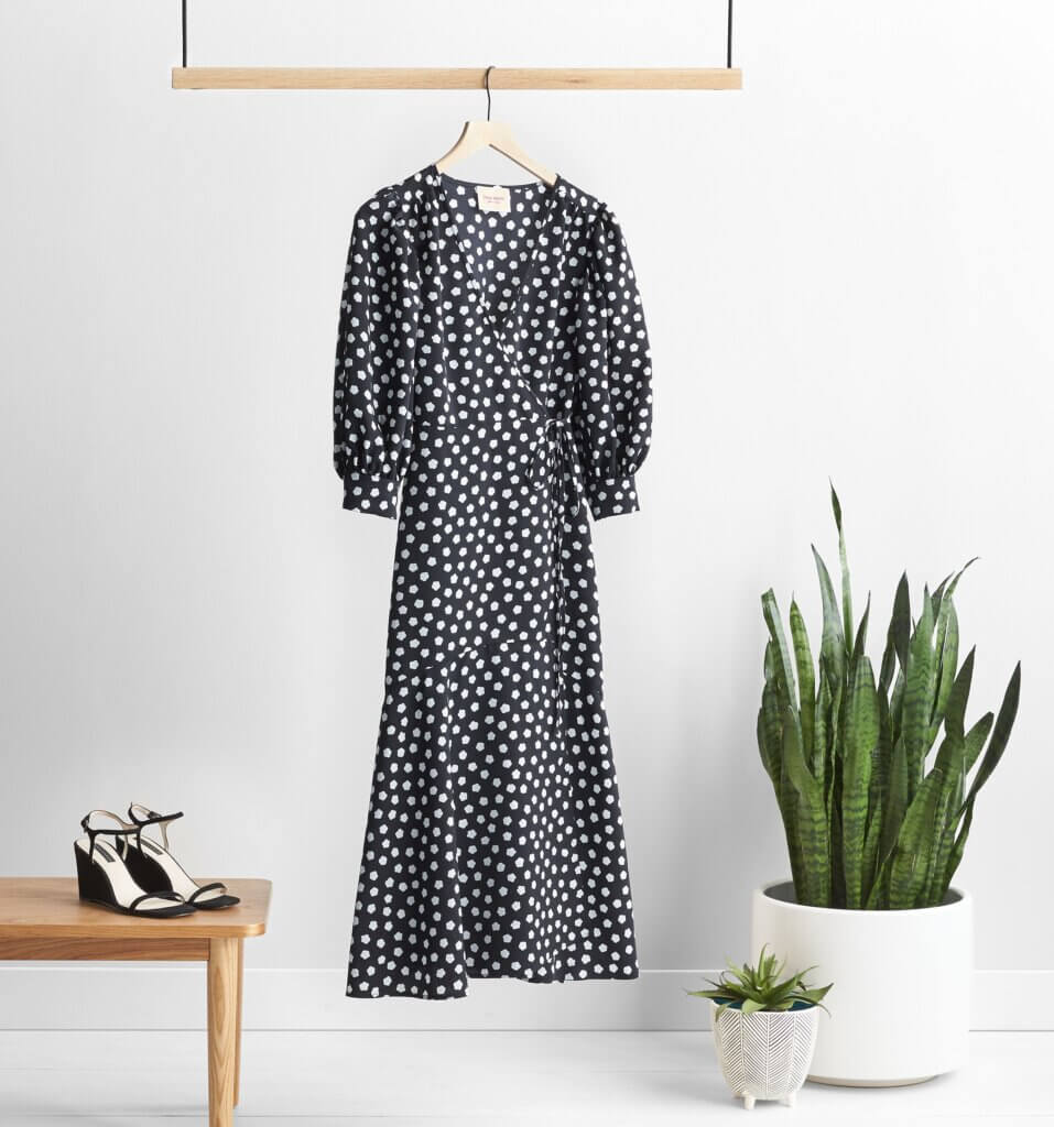 Stitch Fix maxi dress in black with white abstract floral print and balloon-sleeves next to black heels and potted plants.