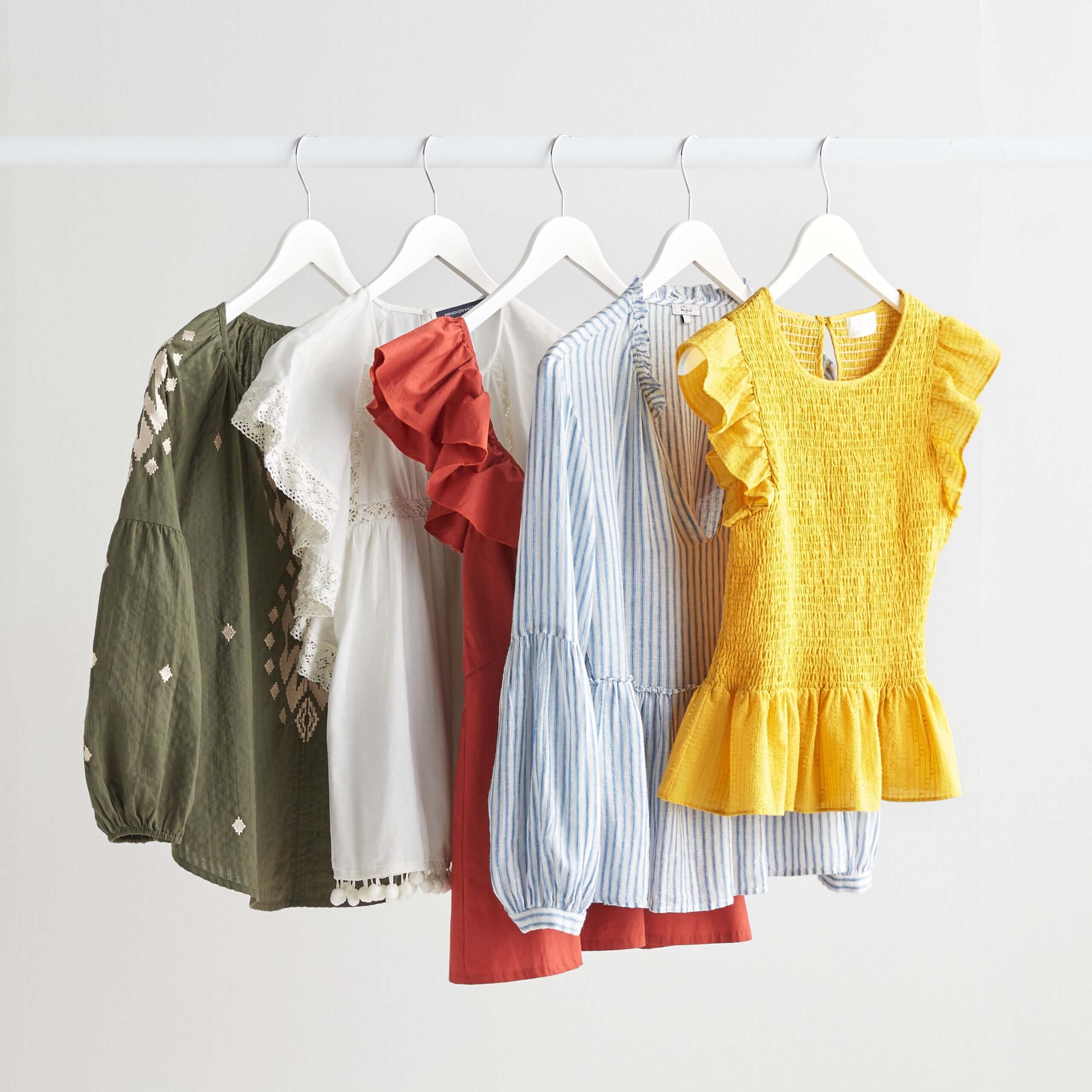 Stitch Fix Desert Daze olive embroidered blouse, white tassel top, red ruffle top, blue striped blouse, yellow smocked top.