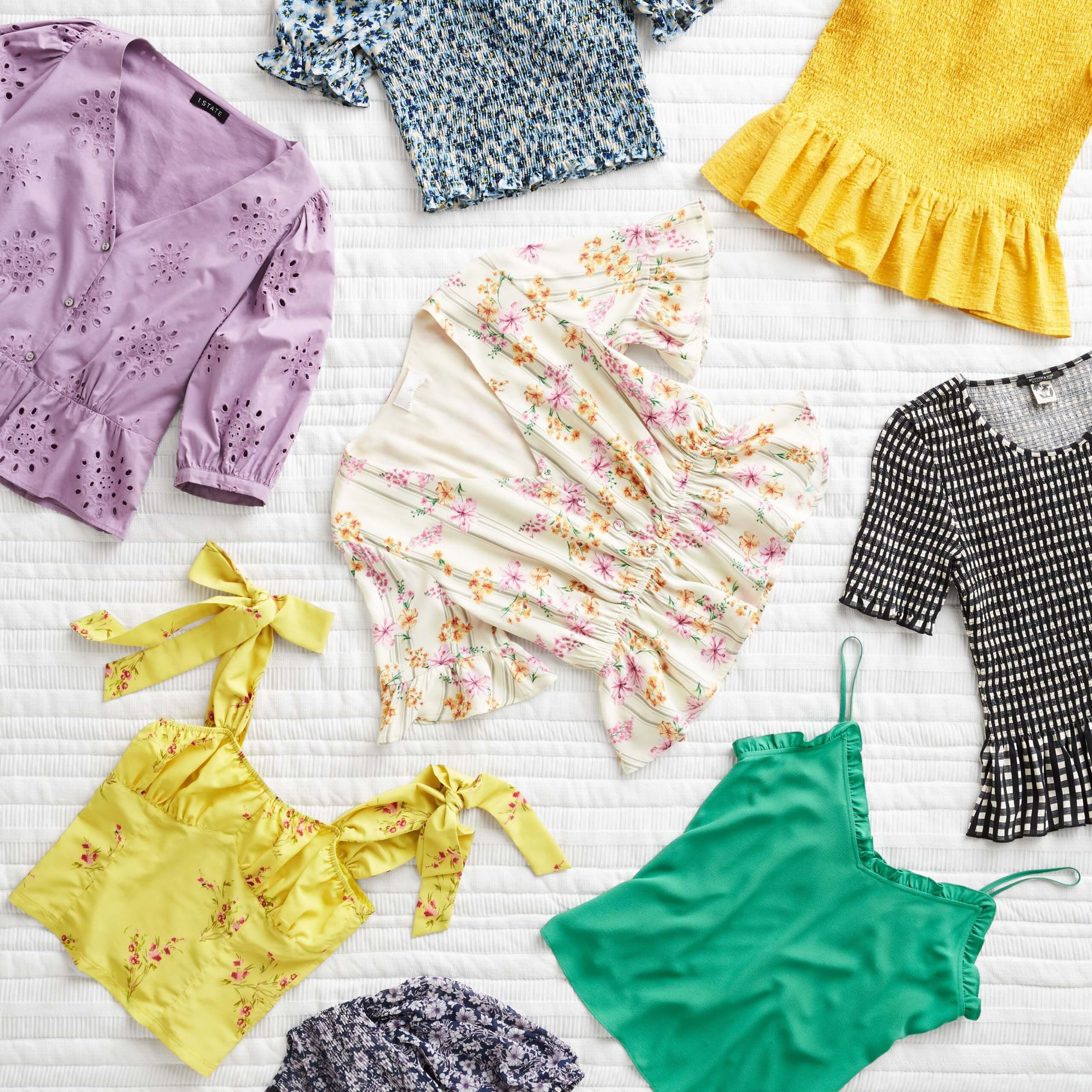 Stitch Fix women’s tops featuring floral wrap blouses, green and yellow camisoles and black and white peplum top.