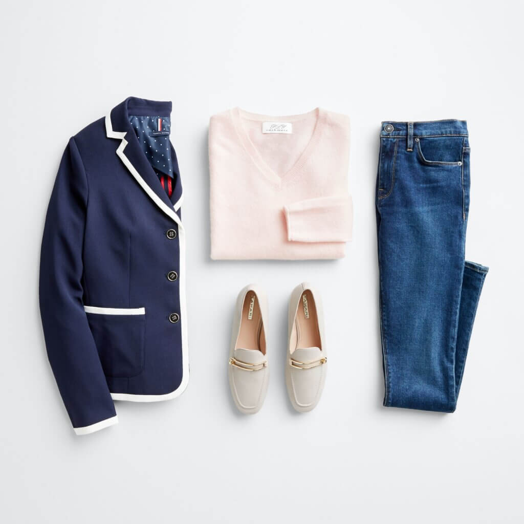 Stitch Fix Women’s outfit featuring jeans, pink crewneck sweater, navy blazer with white piping and off-white loafers.