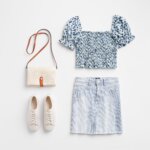 Stitch Fix Women’s Easter outfit featuring striped denim skirt, blue ditsy floral smocked top with puff sleeves, white sneakers and crossbody bag.