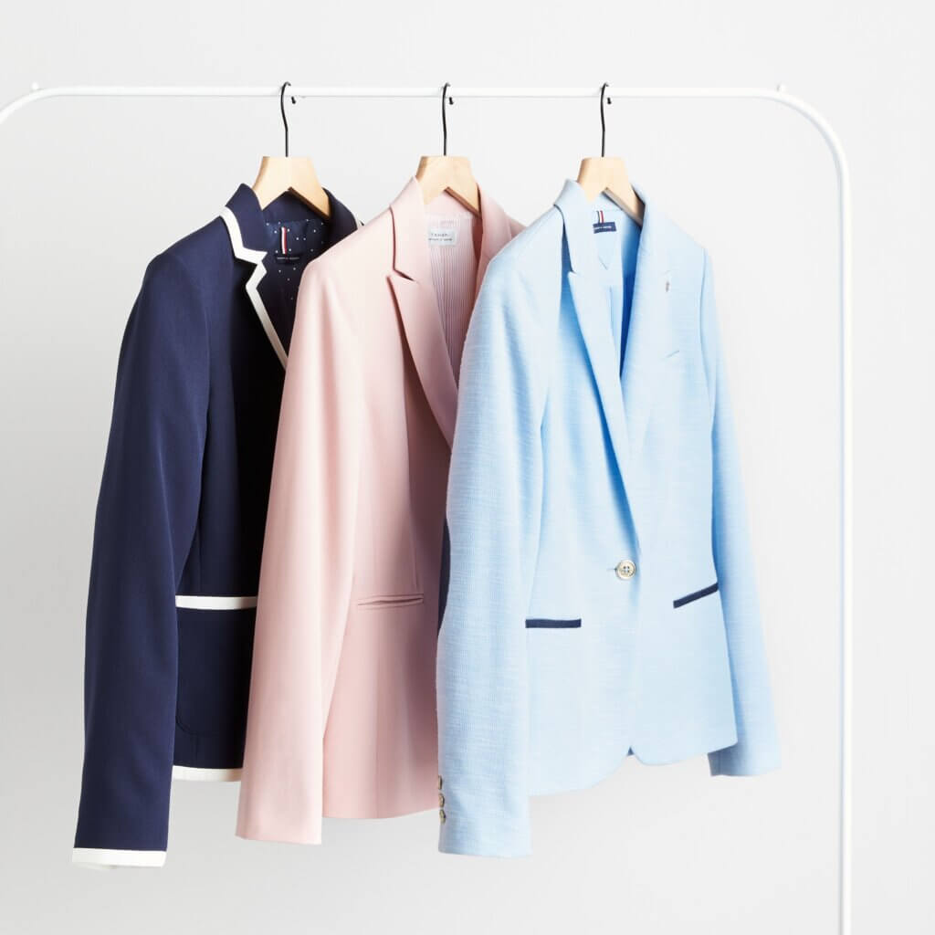 Stitch Fix women’s business casual blazers in navy with white trim, pink, light blue with navy accents on hangers.