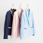 Stitch Fix women’s business casual blazers in navy with white trim, pink, light blue with navy accents on hangers.