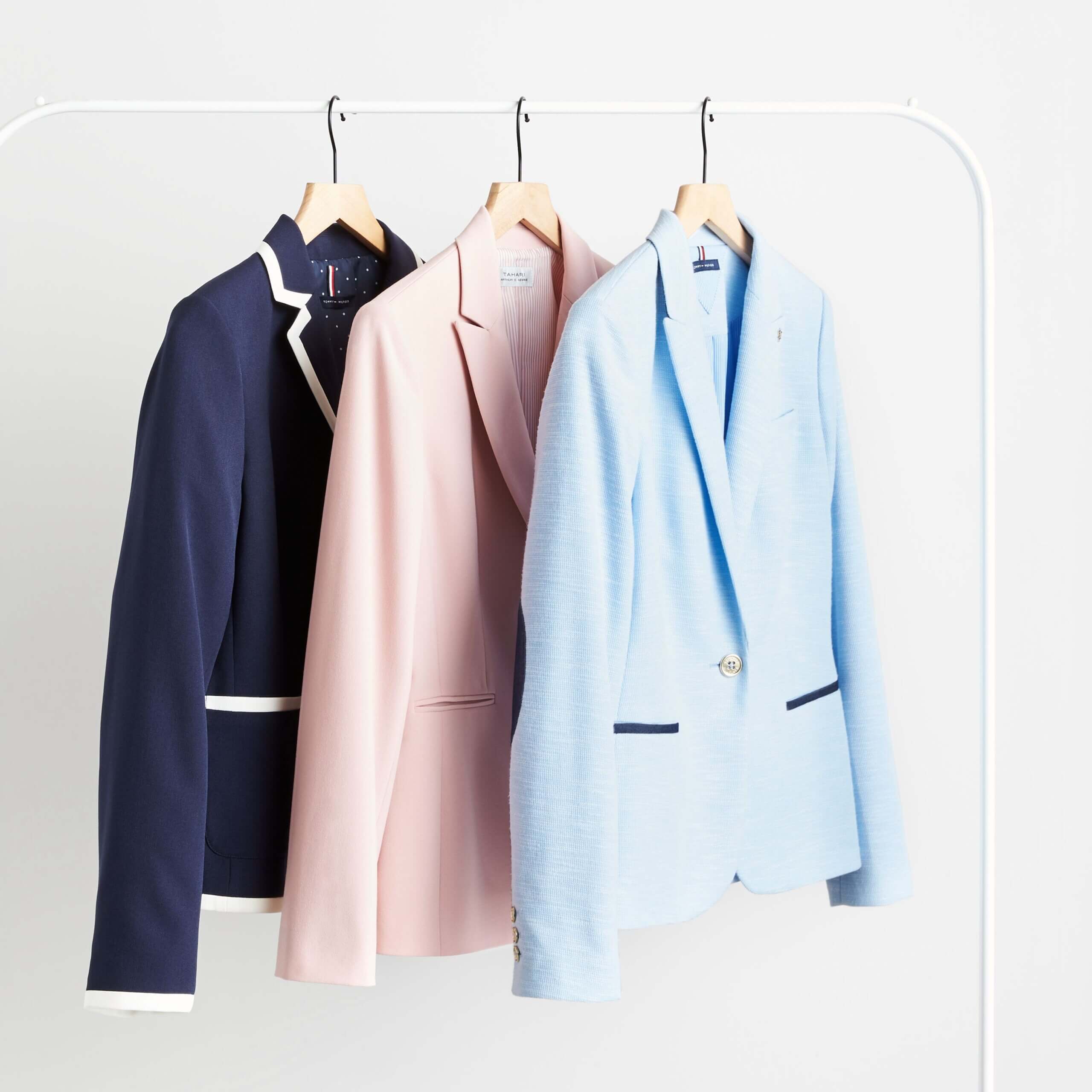 Stitch Fix women’s business casual blazers in navy with white trim, pink, light blue with navy accents on hangers.