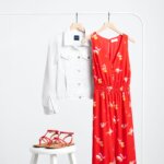 Stitch Fix Women’s Collection featuring red floral wide-leg jumpsuit with white denim jacket and red strappy sandals.