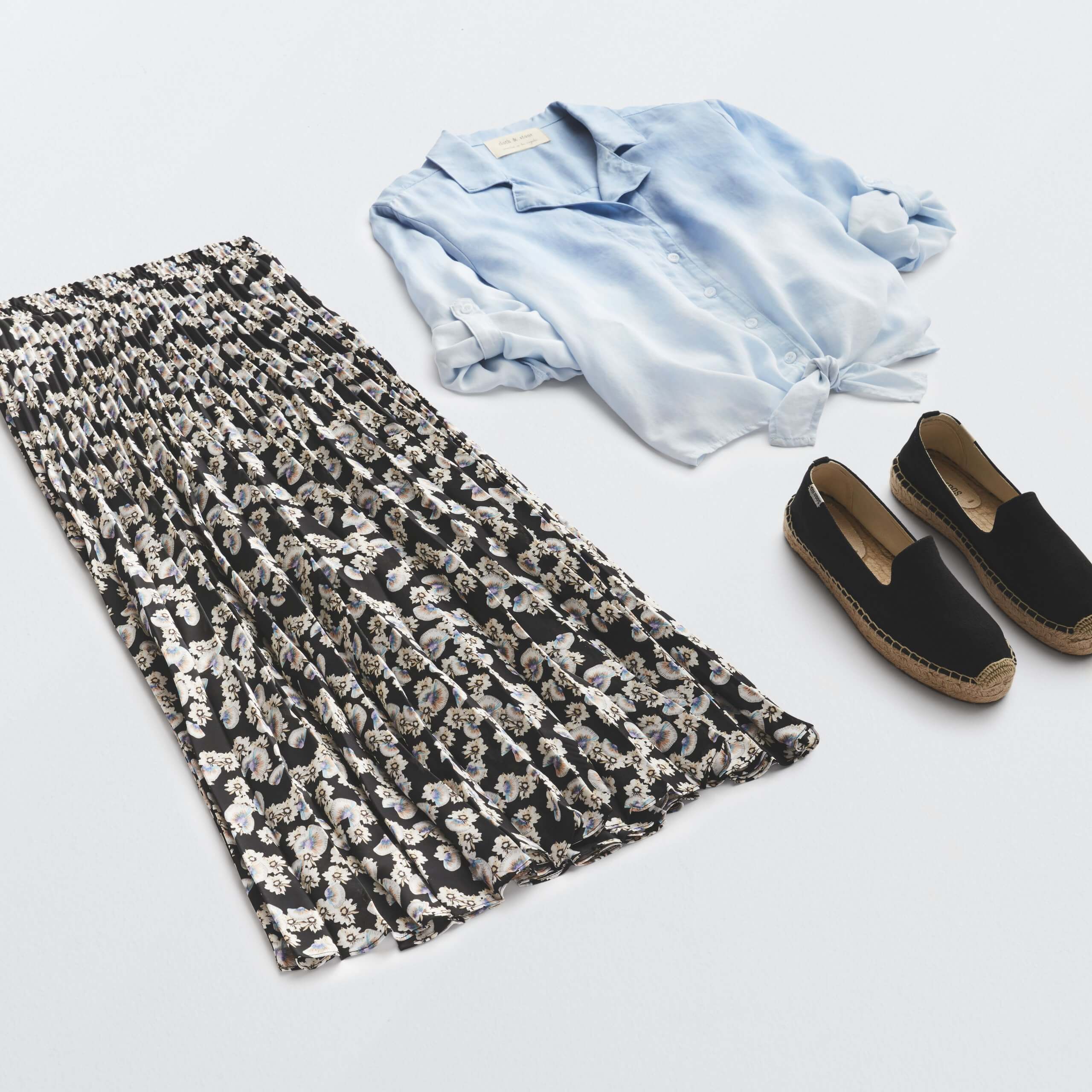 Stitch Fix Women’s outfit laydown featuring floral pleated midi skirt, chambray button-front shirt and black espadrille flats.