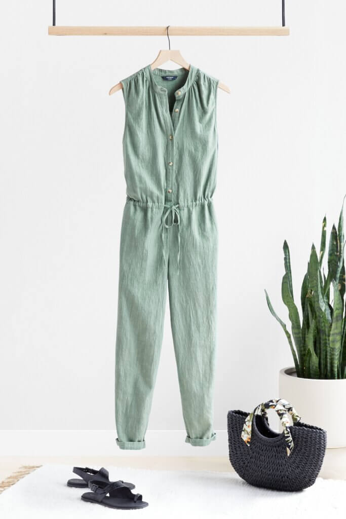 Stitch Fix Women’s Collection featuring light green jumpsuit with drawstring waist, black sandals and black straw tote.