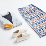 Stitch Fix women’s outfit laydown featuring off-white sneakers, navy shirt under grey and yellow cardigan sweater and striped maxi skirt.