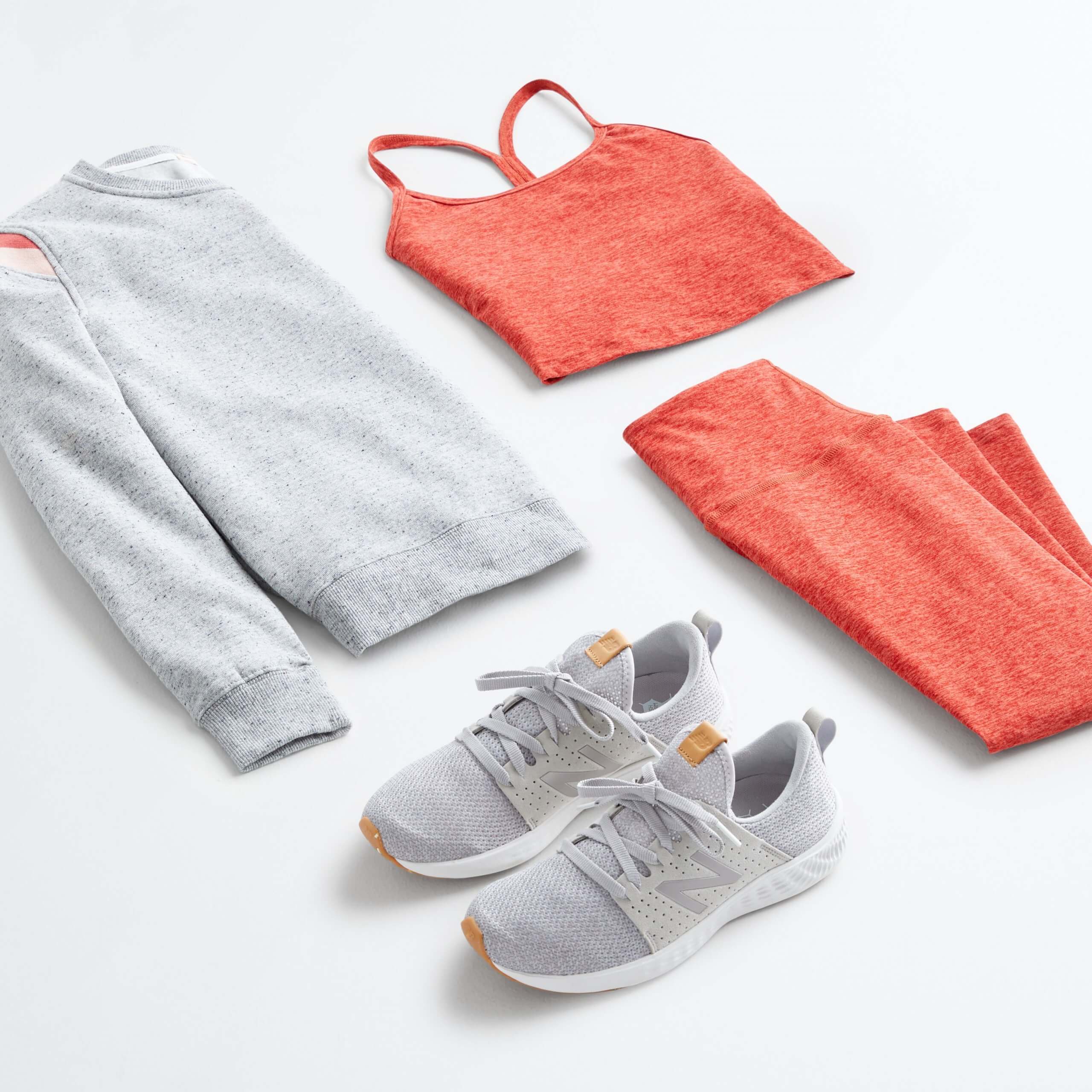 Stitch Fix women’s 4th of July outfit laydown featuring red sports bra and matching leggings, grey crew neck sweatshirt and grey sneakers.