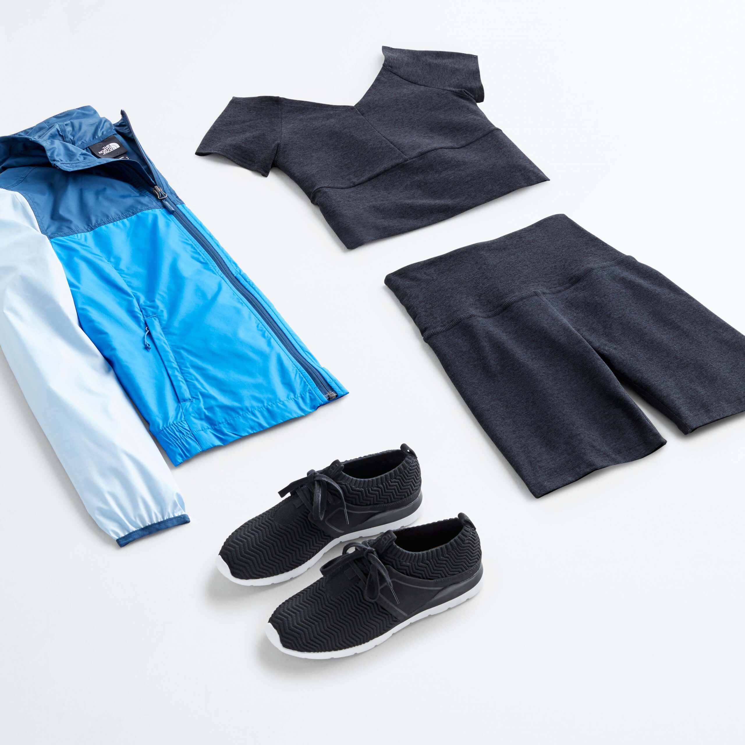 Stitch Fix Women’s biker short outfit featuring black shorts and top set styled with black sneakers and blue jacket.