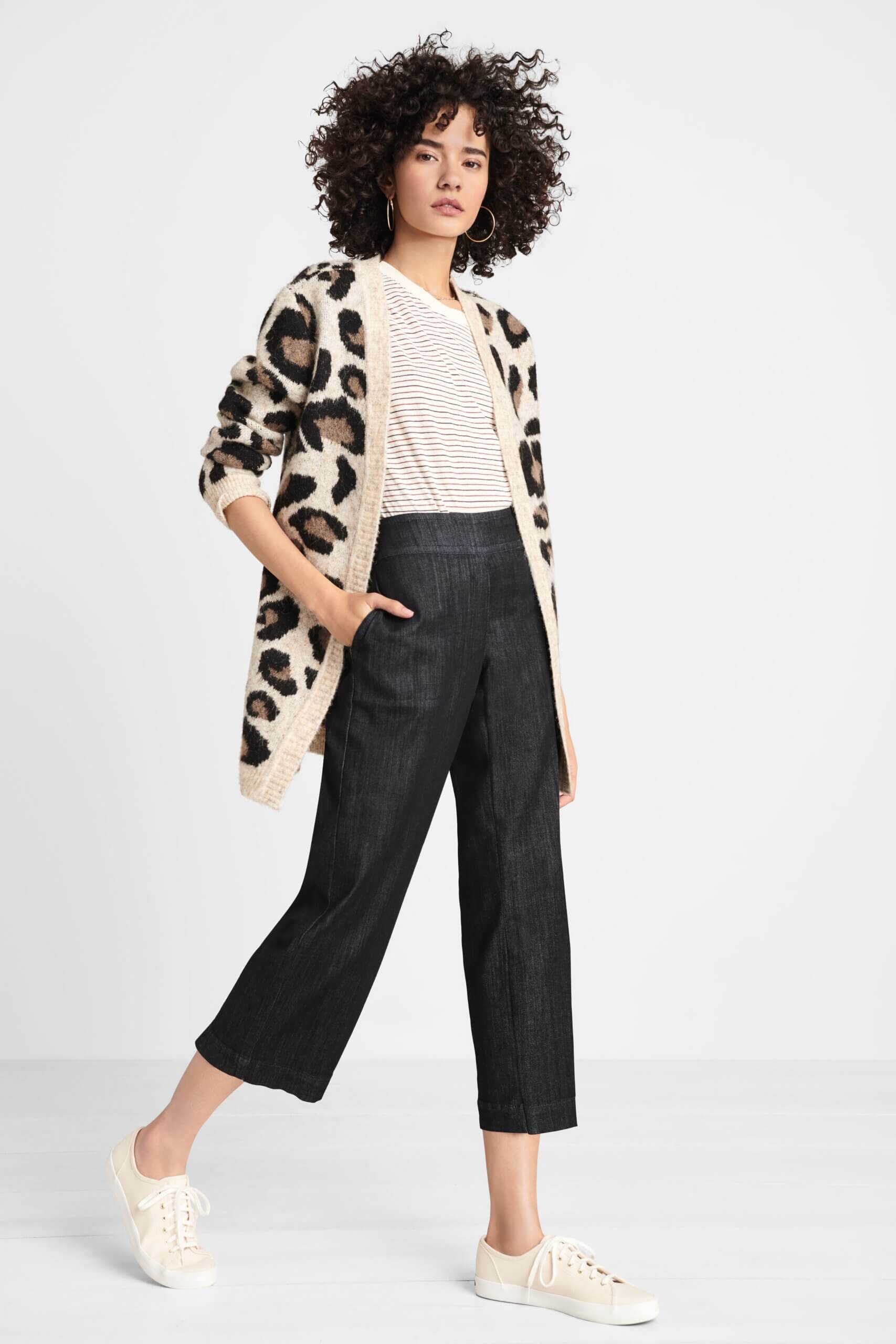 Stitch Fix women's model wearing black wide-leg cropped denim, cream striped tee, leopard print cardigan and white sneakers. 