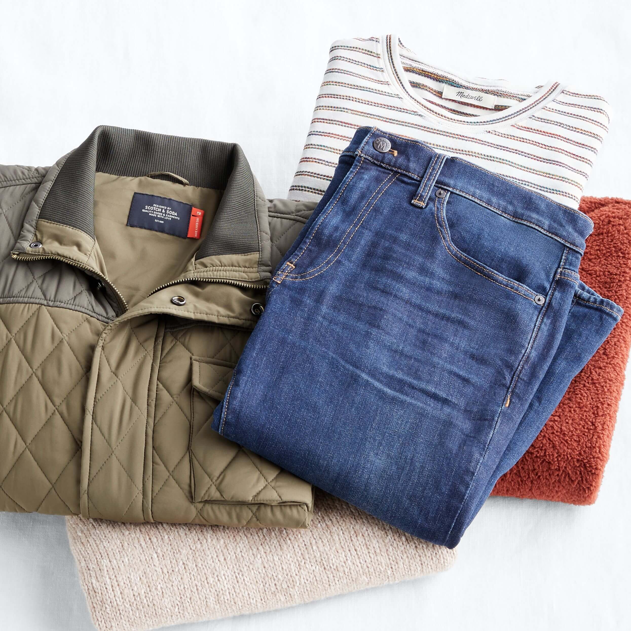 Stitch Fix Women’s sustainable brands lay down featuring blue jeans, tunic pullover, sherpa vest, striped tee, and quilted jacket.