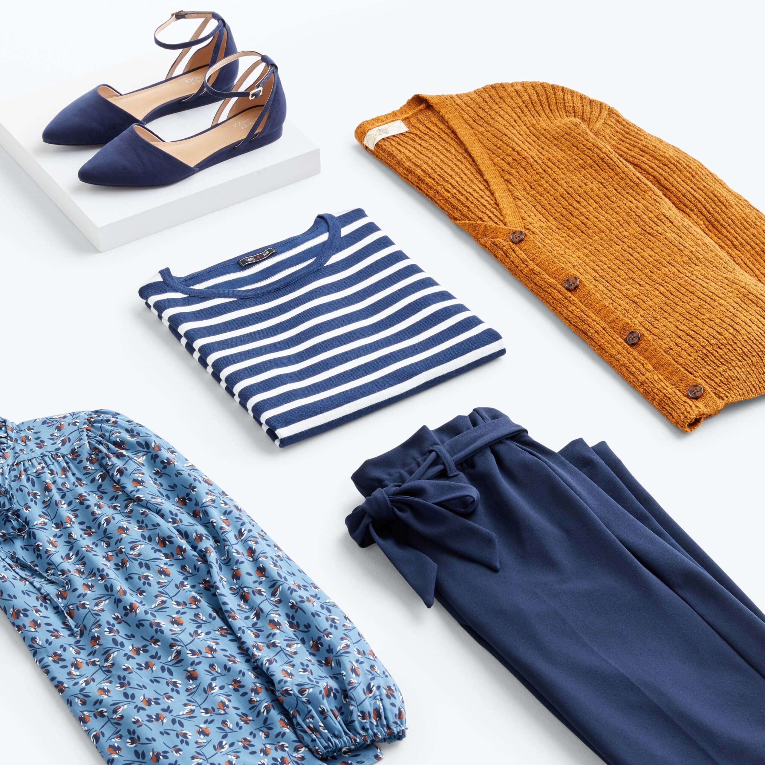 Stitch Fix women’s navy and orange outfit with striped T-shirt, navy pants, orange cardigan, floral blouse and navy flats.