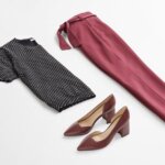 Stitch Fix women’s business casual outfit with black geo-printed short-sleeve sweater, burgundy tie-waist pants and burgundy heels.