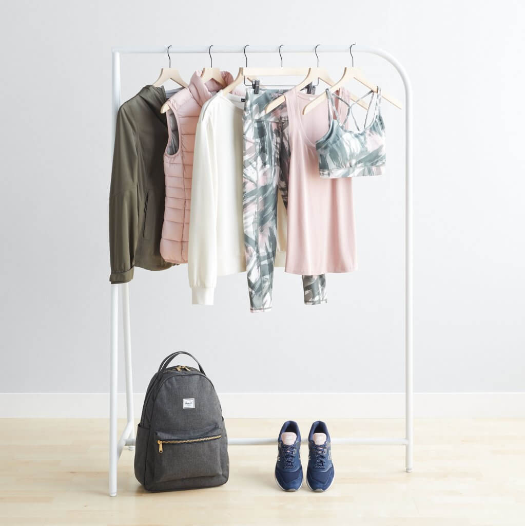 Stitch Fix women’s olive jacket, blush vest, sweater, patterned leggings and sports bra, blush tank, backpack and sneakers.