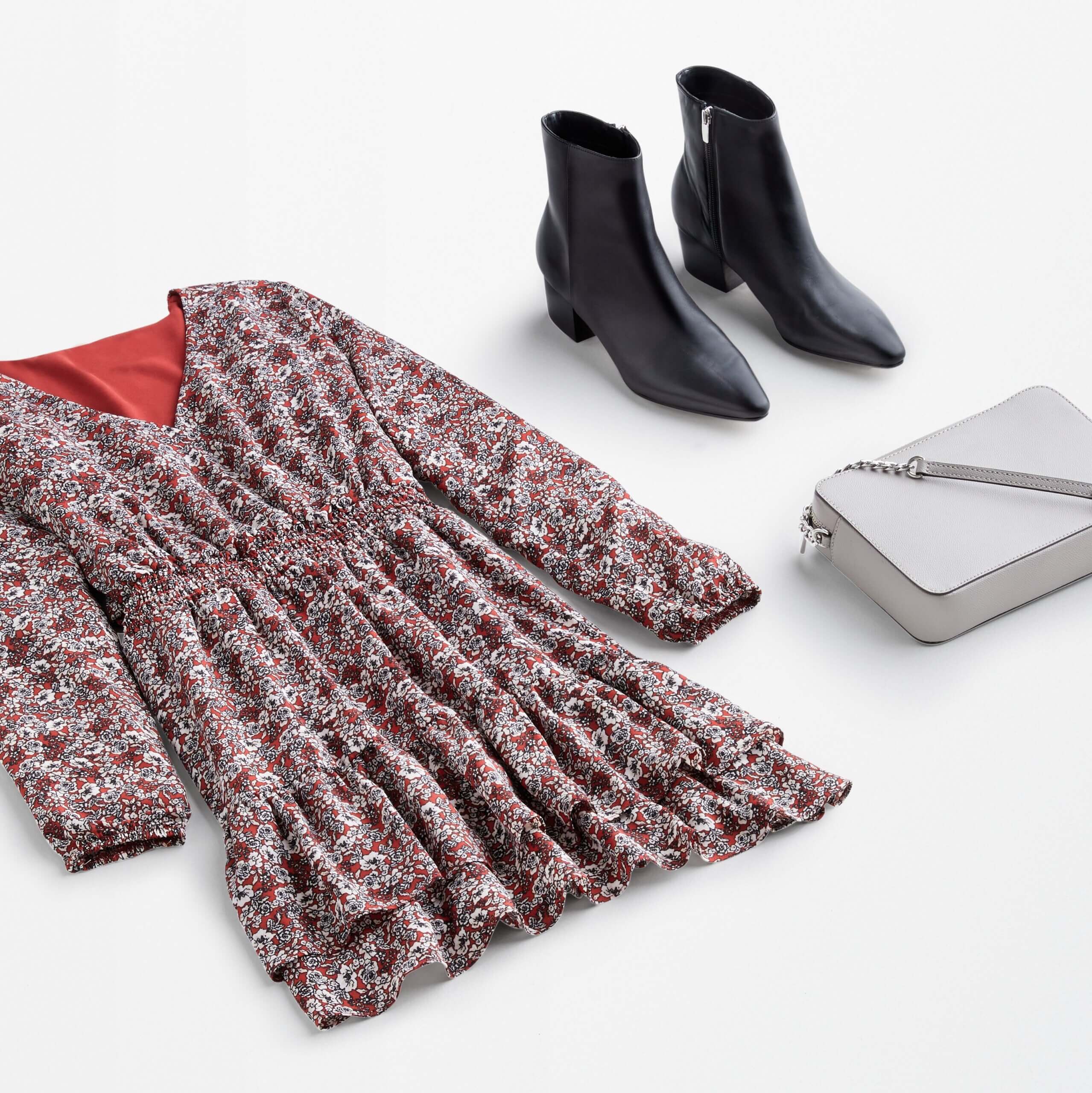 Stitch Fix Women’s date night at home featuring ditzy floral red dress with ruffle trim, black booties and grey bag.