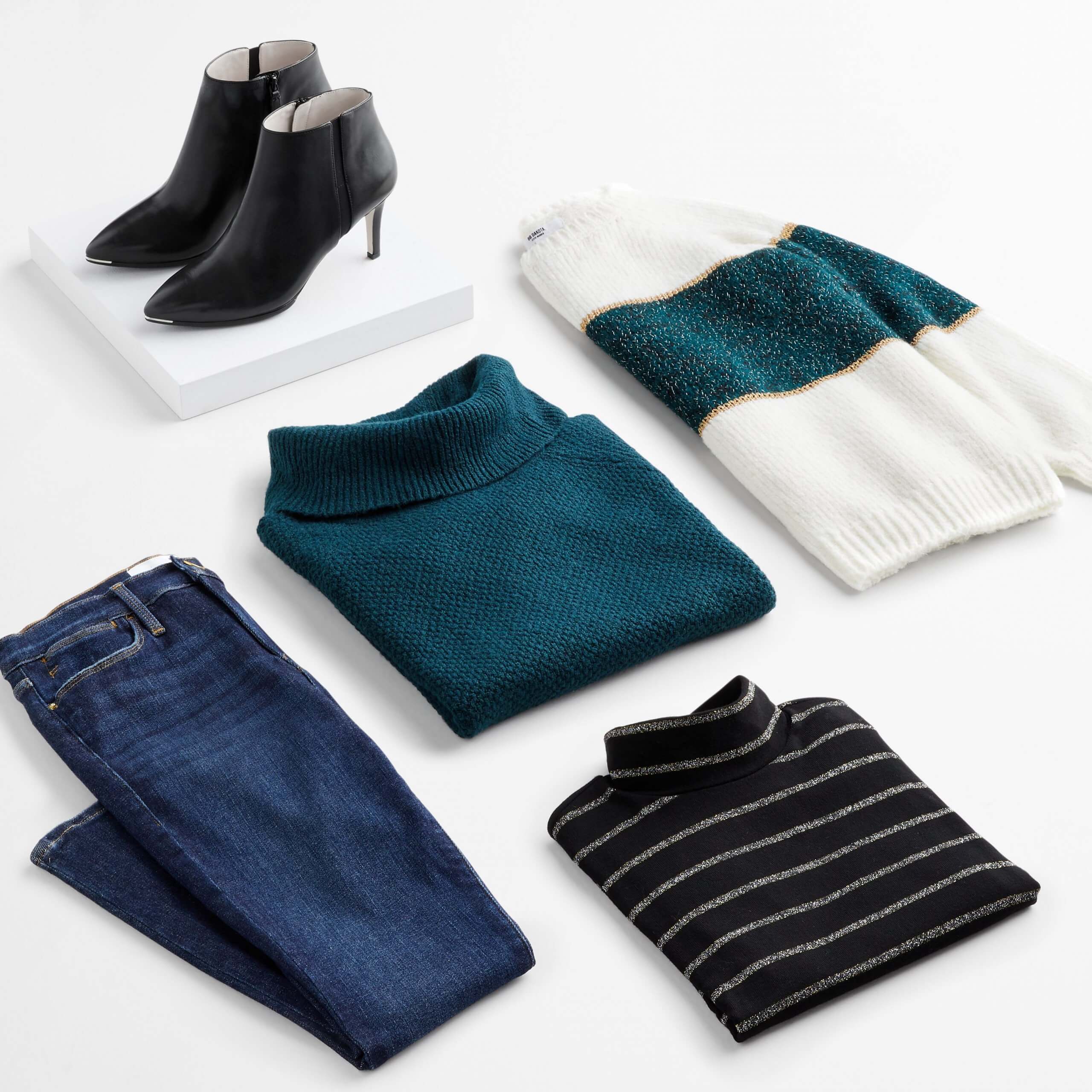 Stitch Fix Women's outfit laydown featuring skinny jeans, teal green turtleneck sweater, white and green pullover, black striped turtleneck, and black heeled booties on a white box.