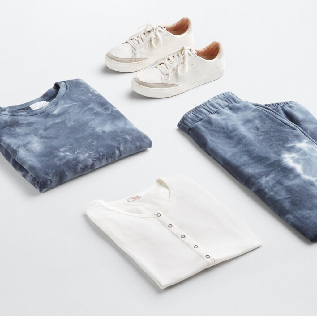 Stitch Fix Women’s Outfit featuring tie-dye loungewear set, white Henley T-shirt and white sneakers.