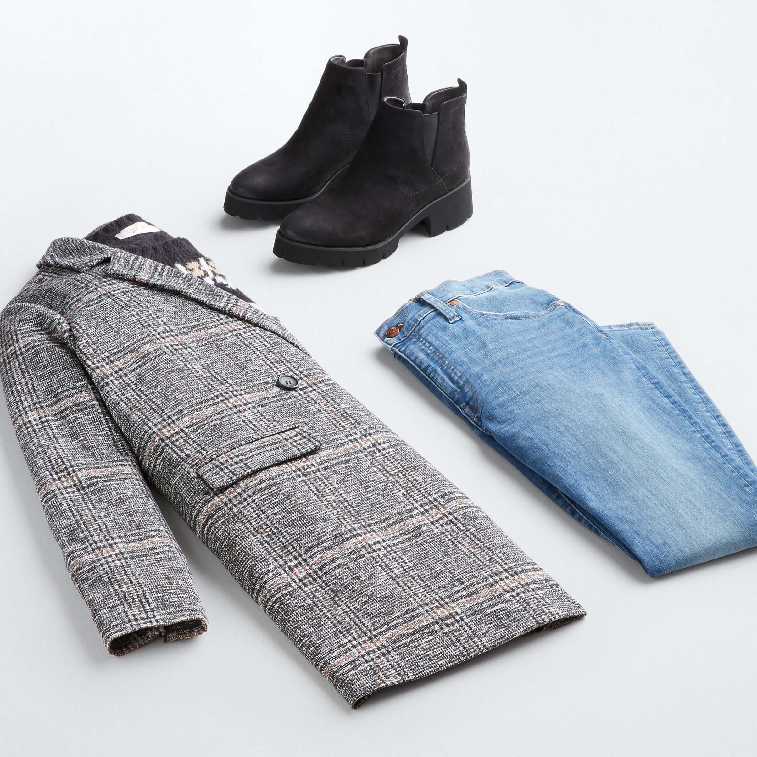 Stitch Fix women’s fall 2021 outfit with black printed sweater, black and brown plaid blazer, blue jeans and black boots.
