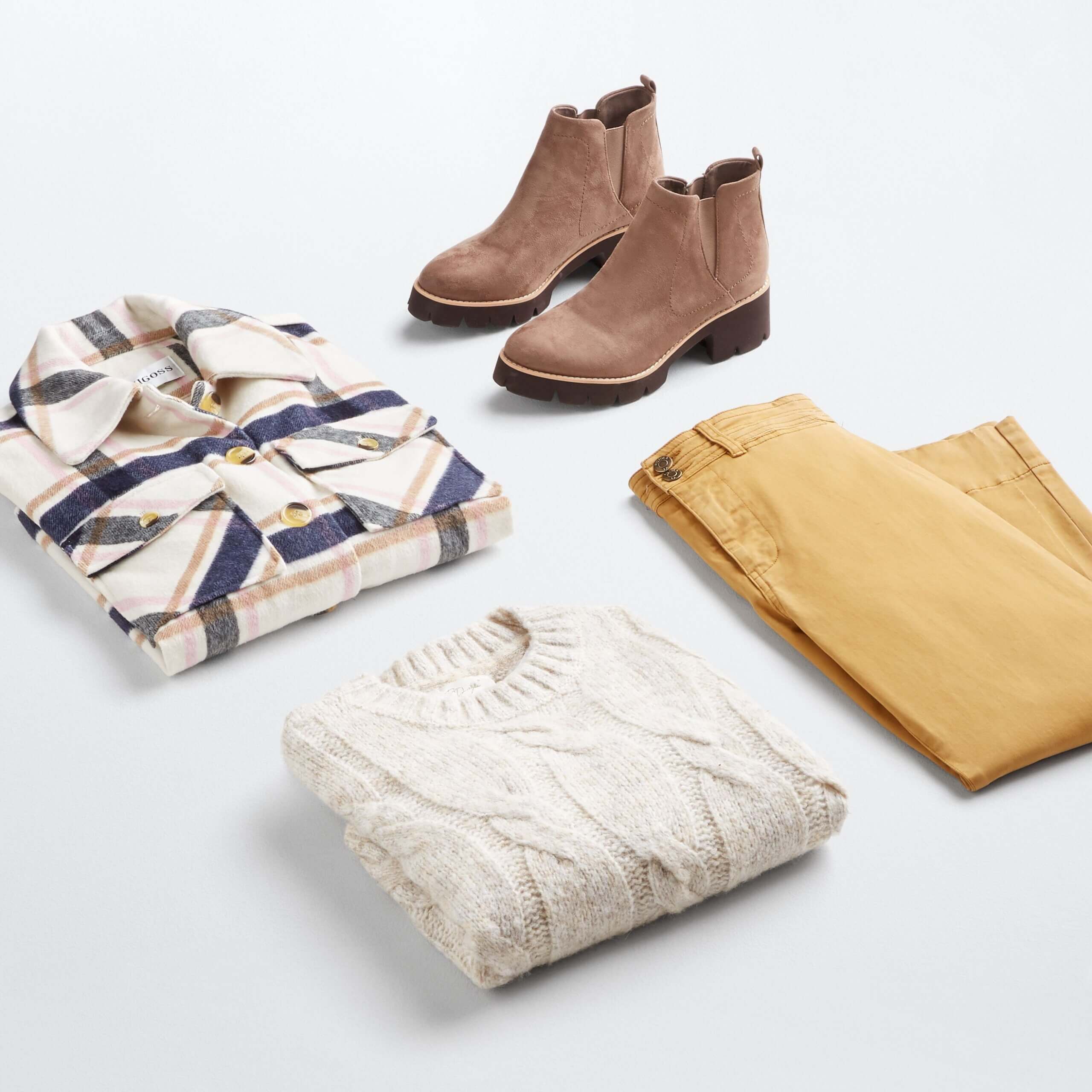 Stitch Fix women's shacket outfit featuring cream, navy blue and orange plaid shacket, cream sweater, yellow pants and brown boots.