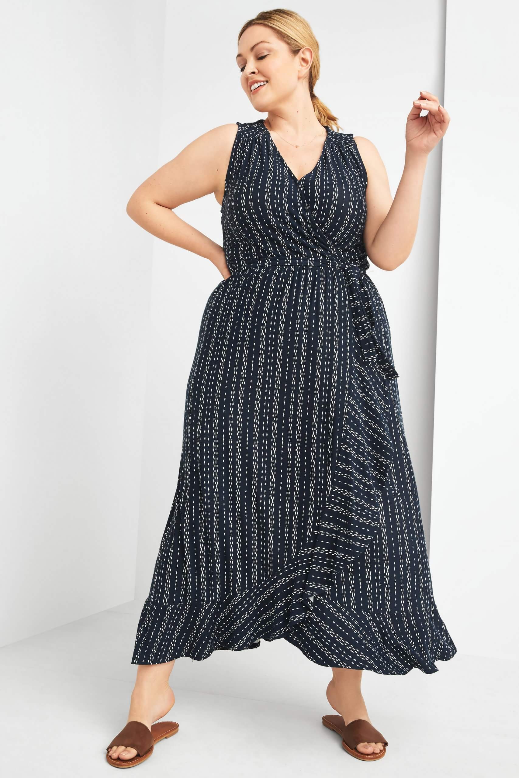 Stitch Fix women’s model wearing boho style navy blue printed maxi- dress with brown slide sandals.