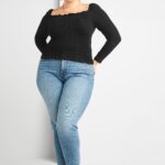 Stitch Fix women’s model in boots with jeans outfit featuring black long-sleeve square-neck top, light-wash skinny jeans and leopard-print ankle boots.