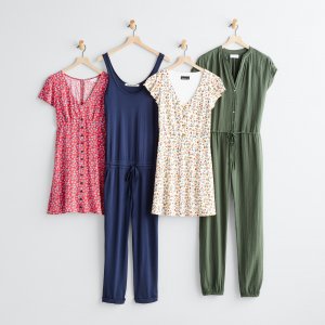 Stitch Fix women’s red printed dress, blue jumpsuit, multi-colored floral dress and olive jumpsuit hanging on wall pegs.