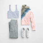 Stitch Fix women’s outfit laydown featuring white leather sneakers, light blue cropped tank, grey joggers and tie-dye hoodie.