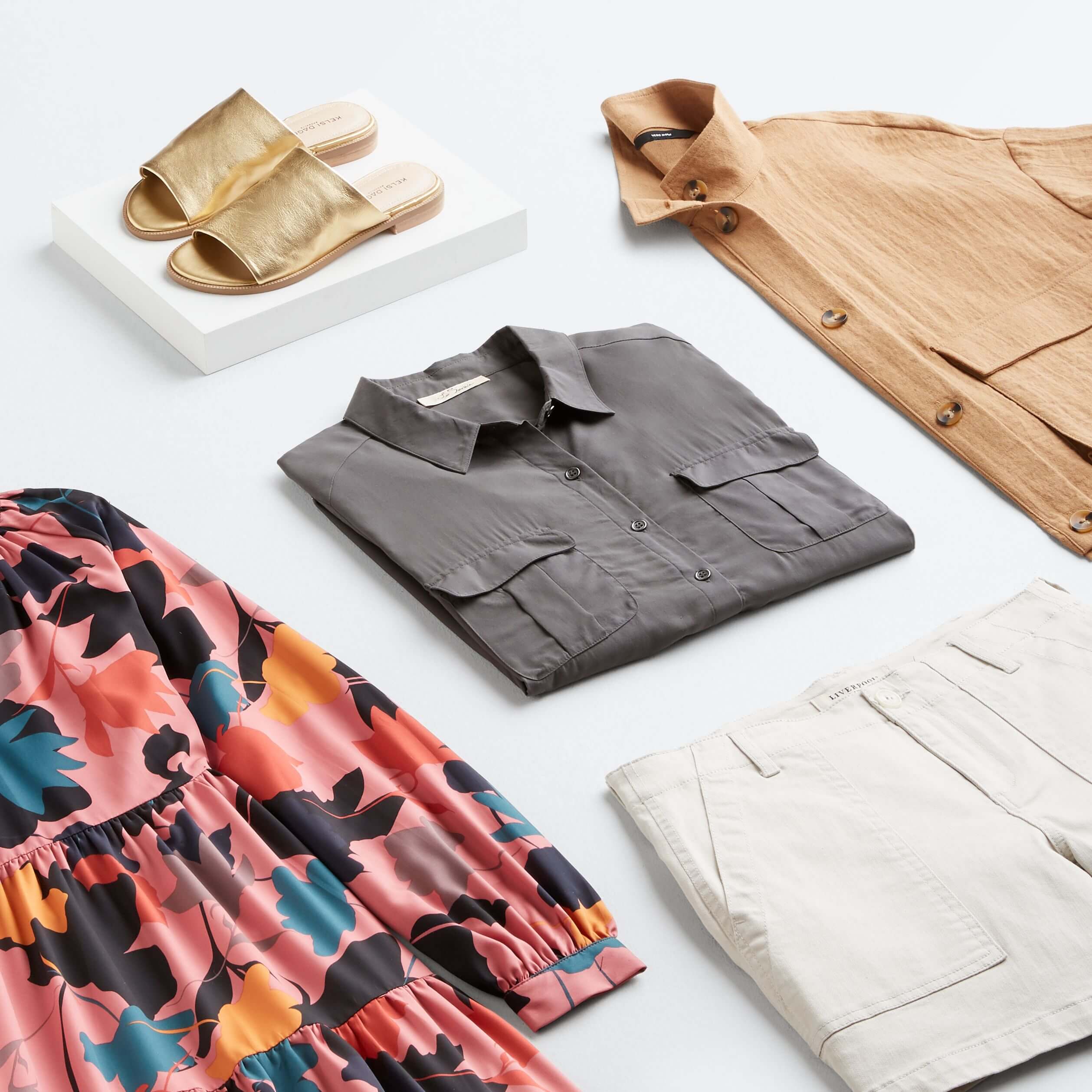 Stitch Fix women’s laydown with different types of fashion styles featuring pink printed dress, grey button-up shirt, white shorts, tan shacket and gold sandals.