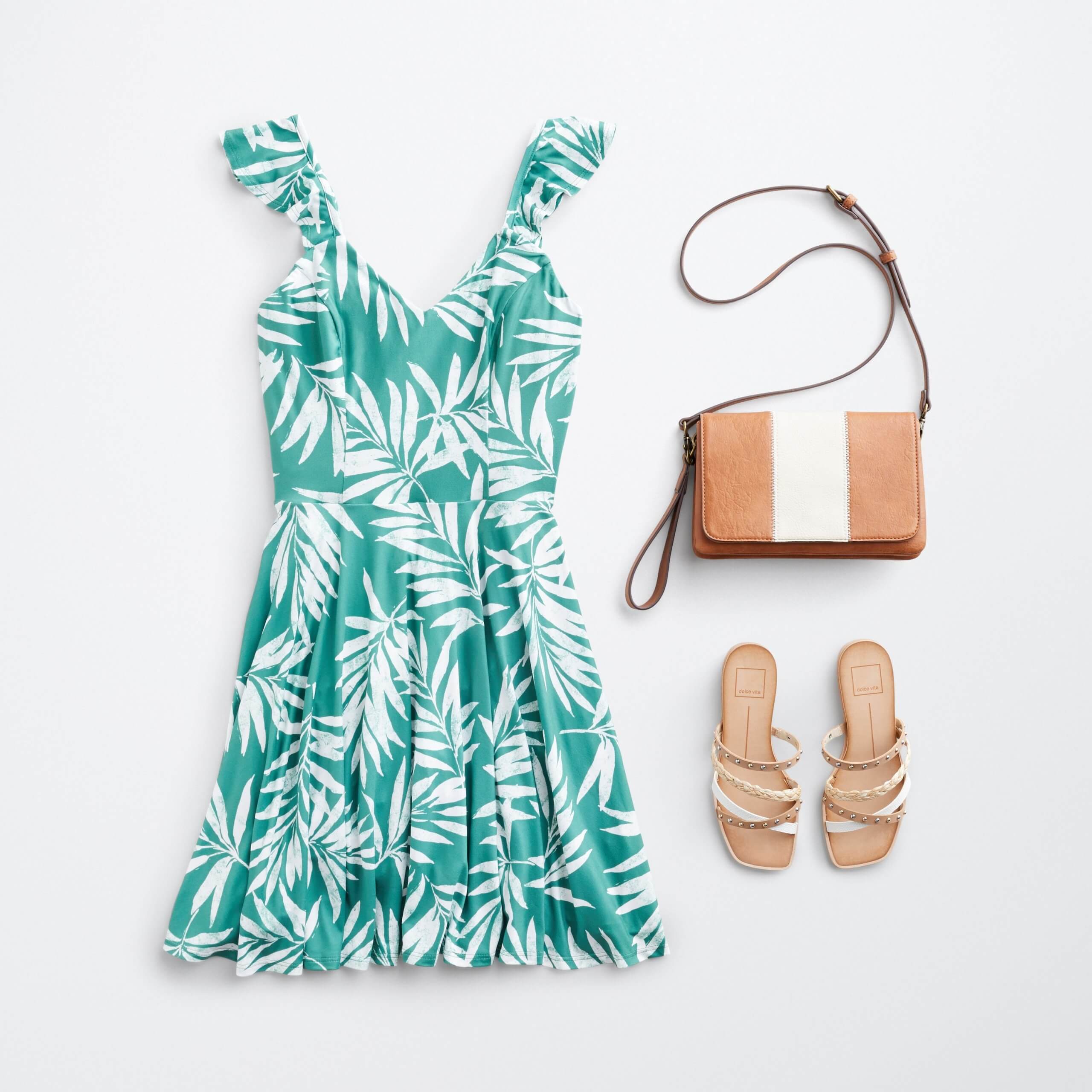 Stitch Fix women’s outfit laydown featuring green tropical print dress, brown and white bag and strappy sandals.