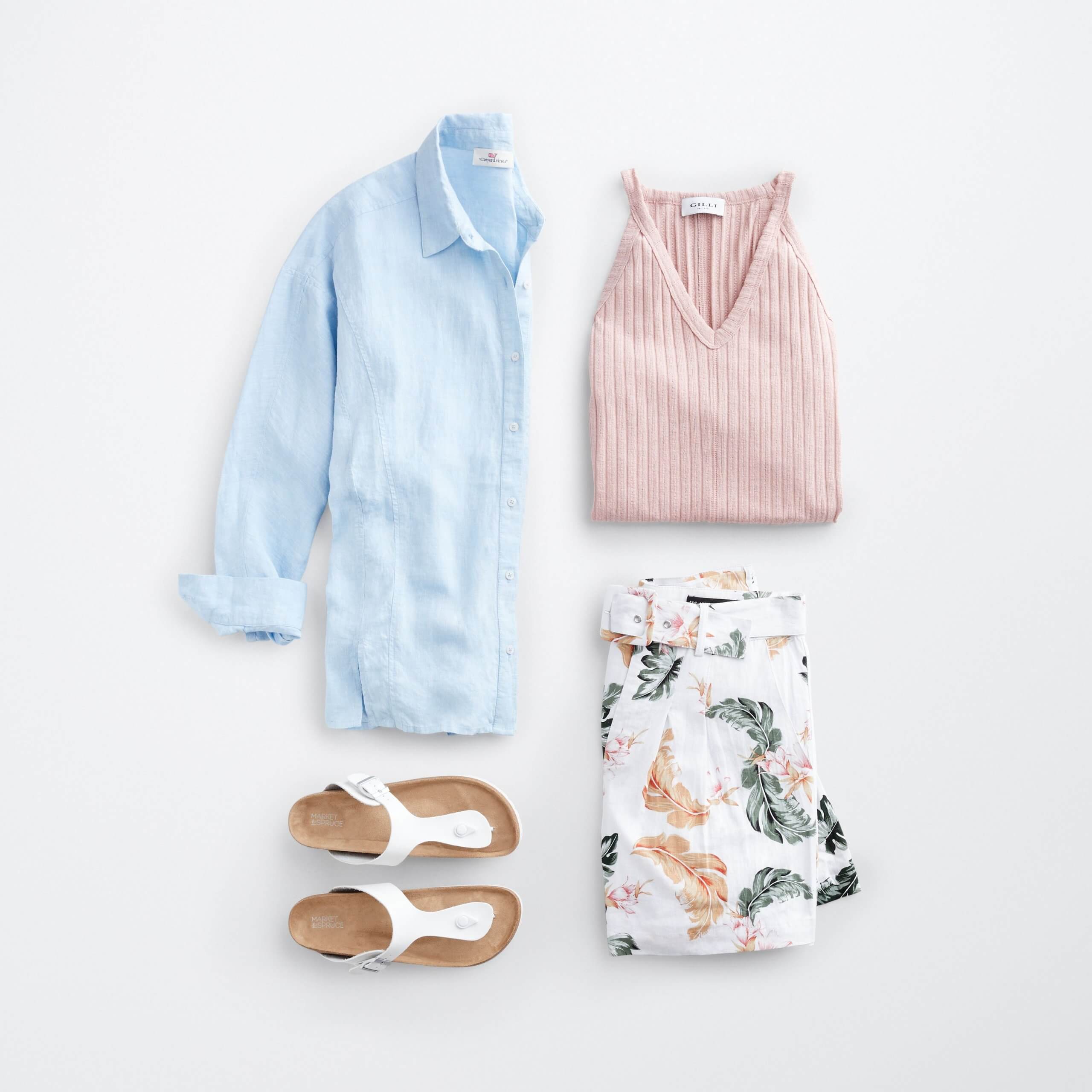 Stitch Fix Women’s outfit laydown featuring a blue button-front shirt, light pink tank top, floral linen shorts and white sandals.