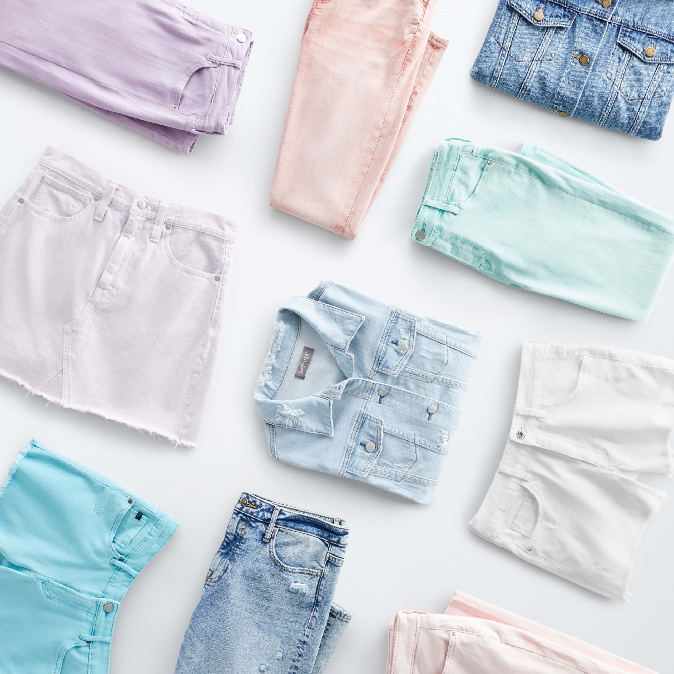 Stitch Fix eco-friendly clothing laydown featuring pastel and indigo jeans, denim shorts, skirt and jackets.