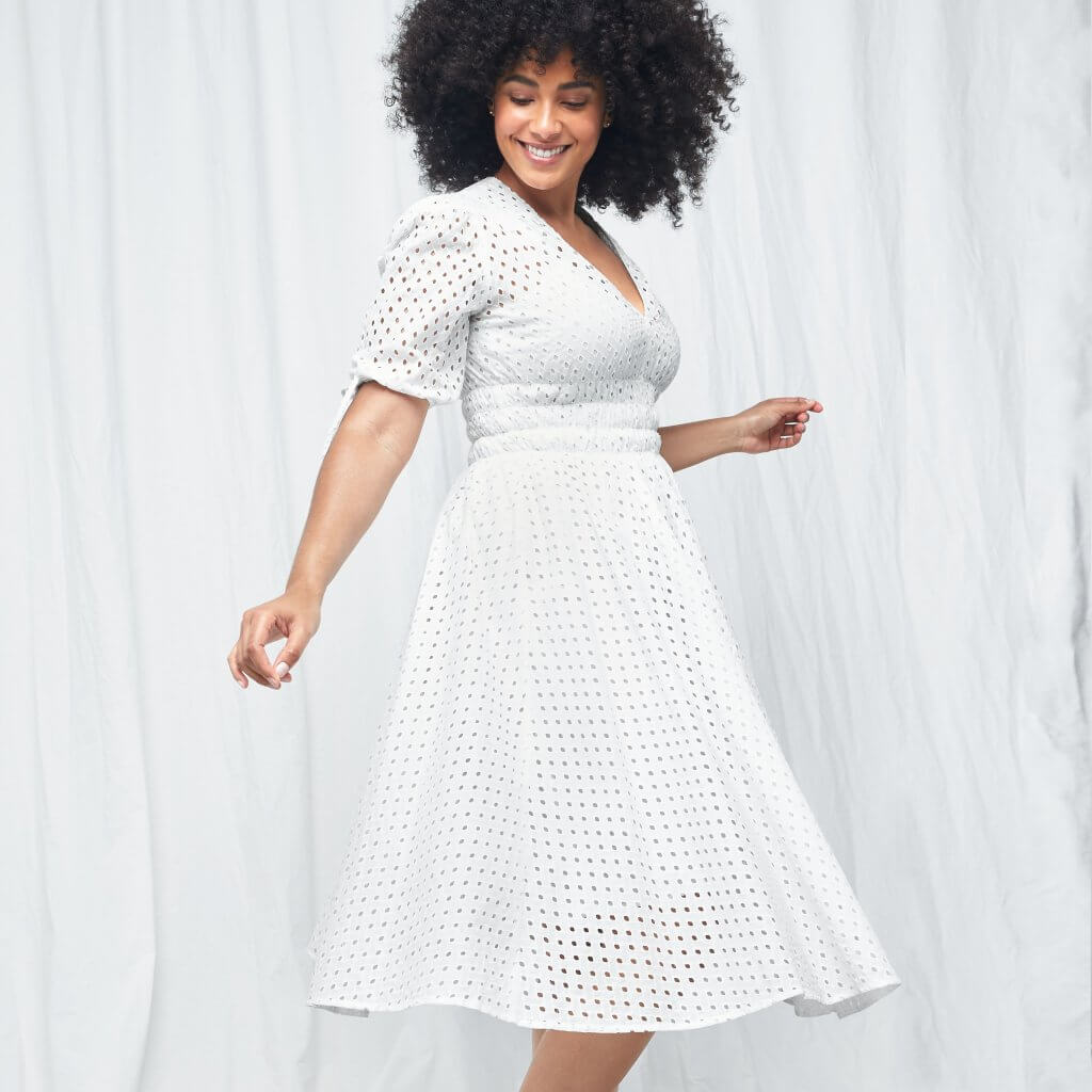 Stitch Fix women’s model in engagement party outfit with short-sleeve white eyelet dress.