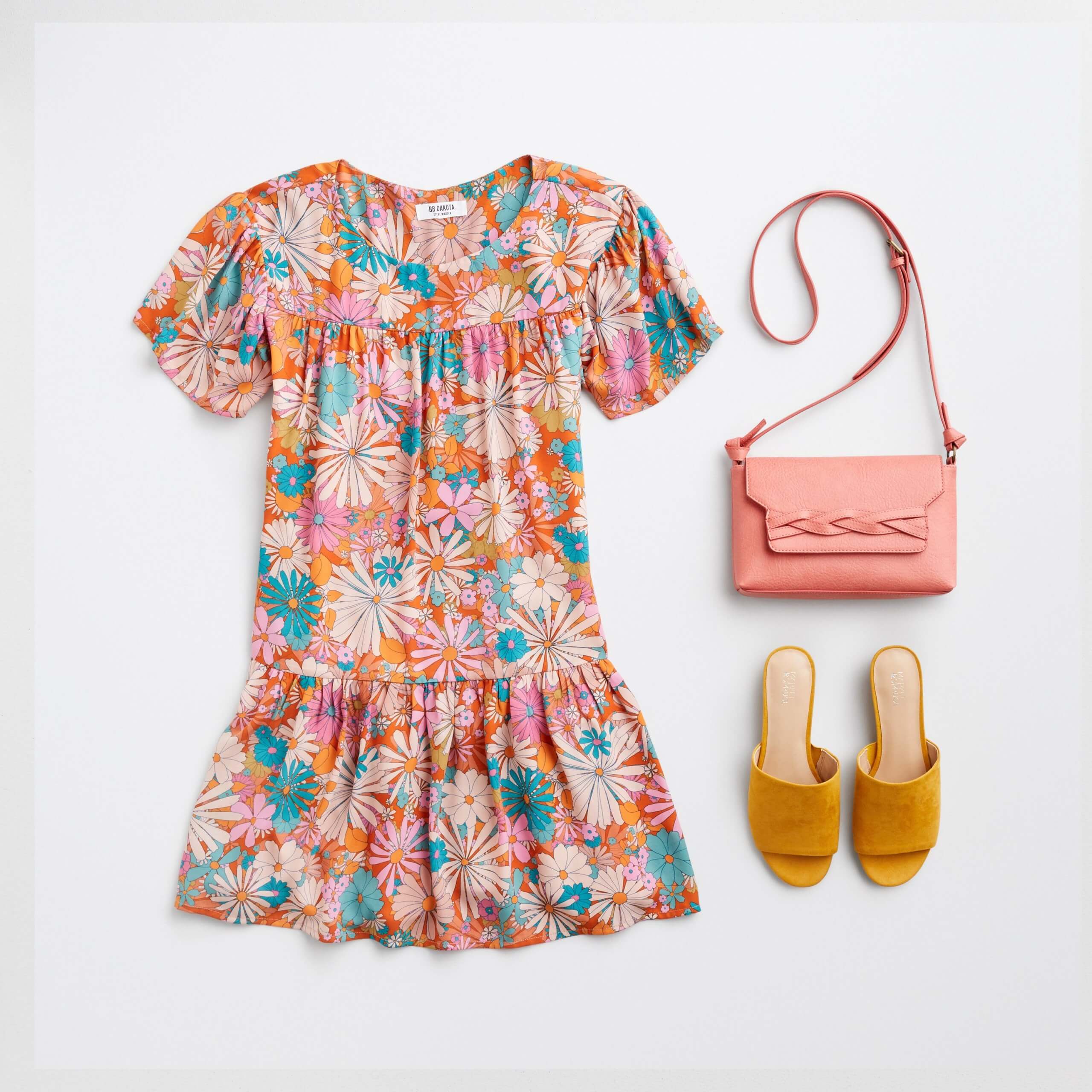 Stitch Fix Women’s orange, pink and green floral printed short-sleeve shift dress, pink crossbody bag and mustard slide sandals.