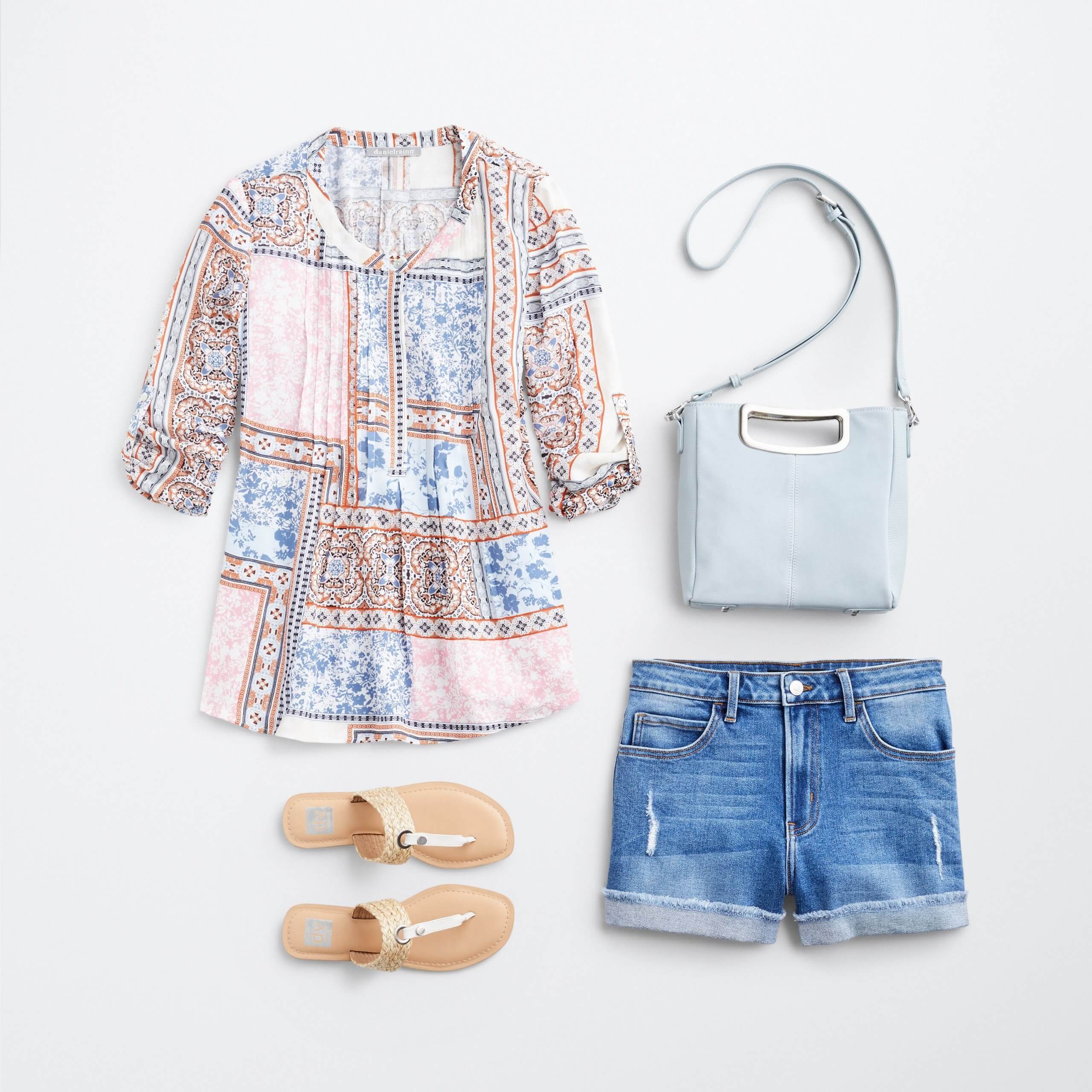 Stitch Fix Women's outfit laydown featuring pink, blue and burnt orange boho print top, white sandals, denim shorts and baby blue crossbody bag. 